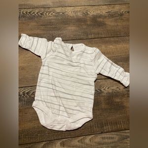 A plain white long sleeve onesie with grey stripes.
